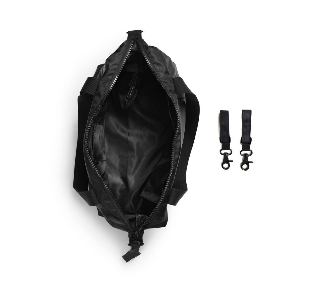 Glansende zwart -veranderende tas